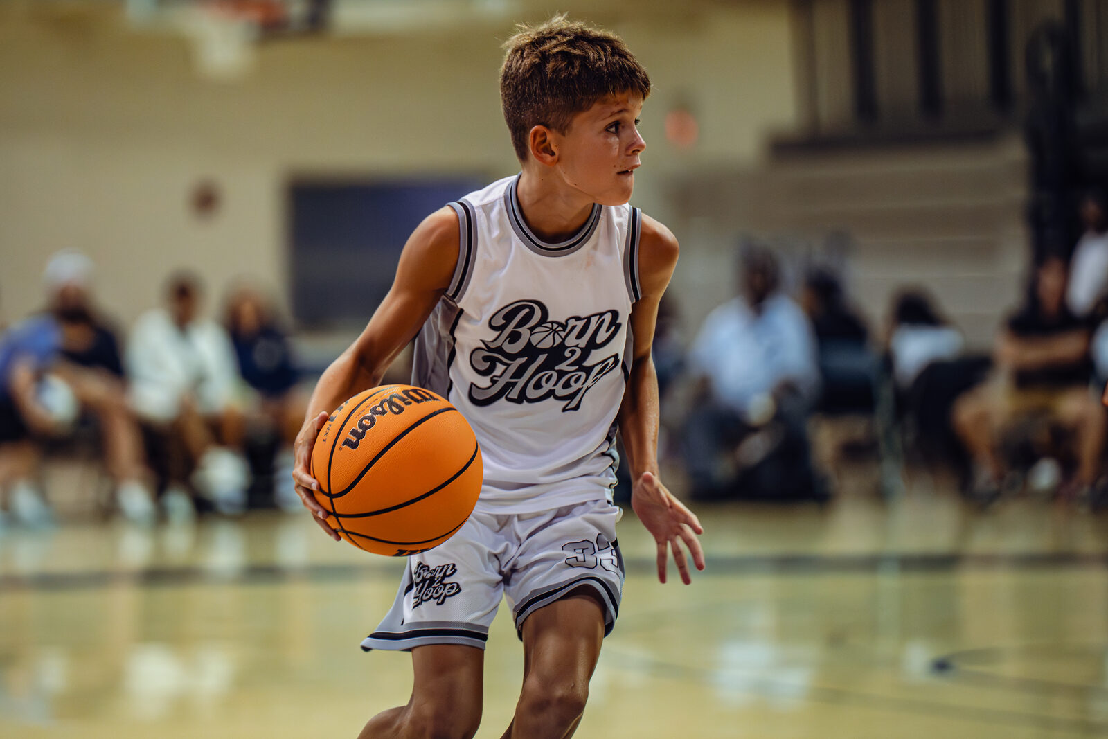 Born 2 Hoop player handling the basketball in a game