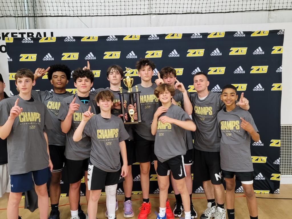 Coach Kevin Miller and youth basketball players celebrating a championship