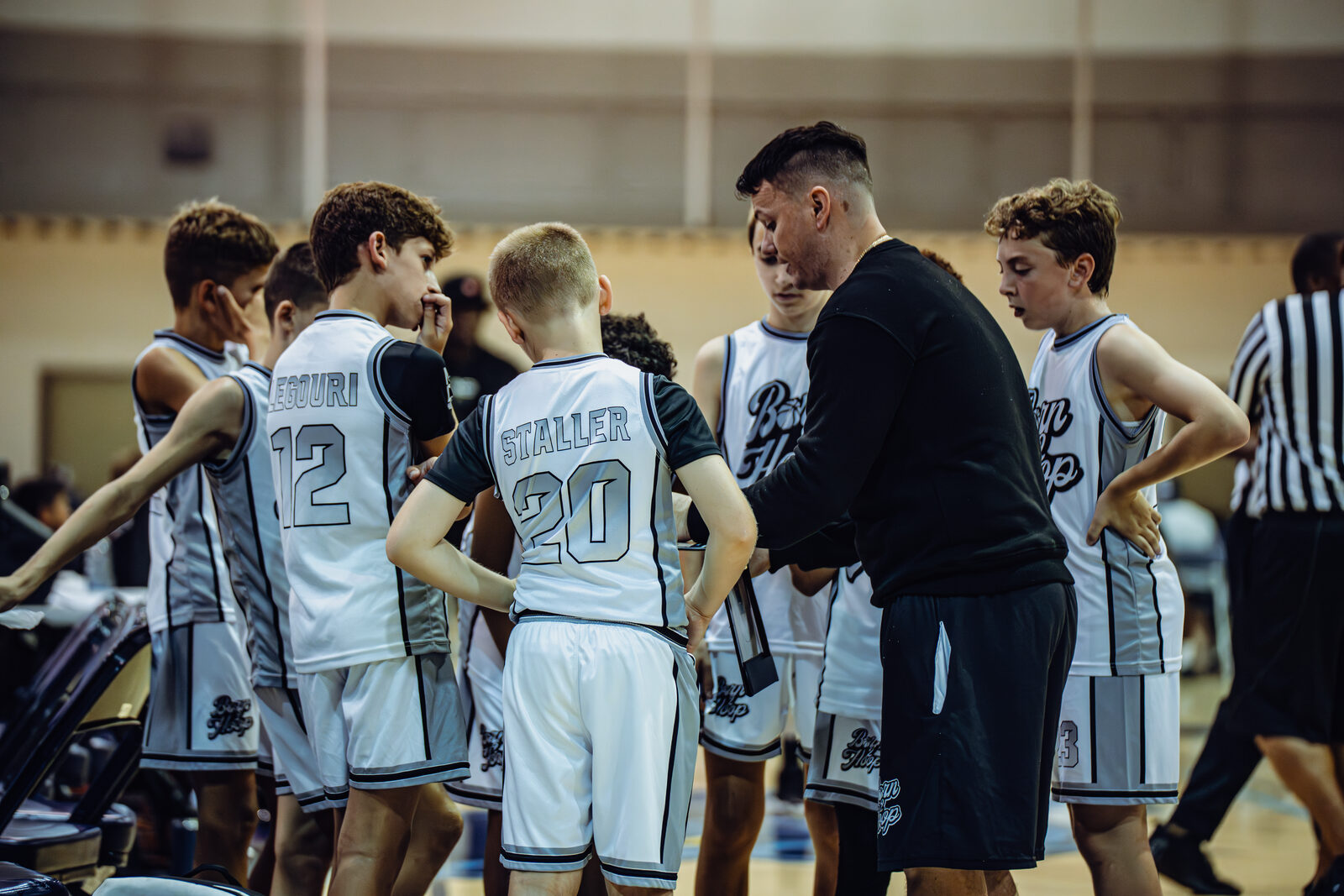Coach Kevin Miller teaching Born 2 Hoop players during a game